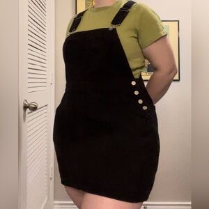 Black overall dress with front heart pocket. M.
